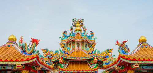 Fototapeta premium Chinese dragon is a symbol of power and wealthy in religious believe of Chinese people. In Chinese Taoism monastery, dragon is presented as powerful decoration on the roof, wall around the compound.