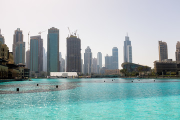 Fototapeta na wymiar Cityscape and a large pool in Dubai