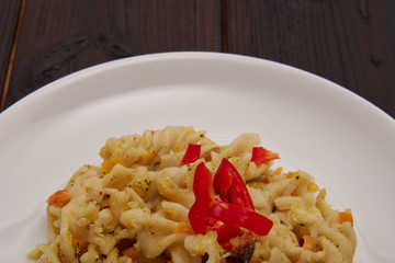 Pasta with vegetables and cheese on a table