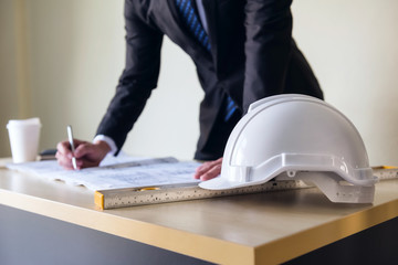 Engineering helmet on Businessman table