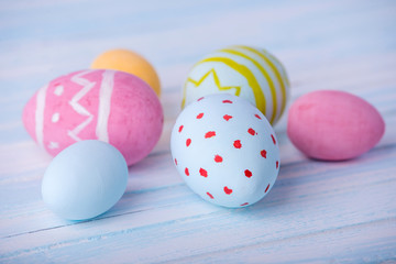 Colorful Easter eggs hand painted on a blue background. Holiday spring card
