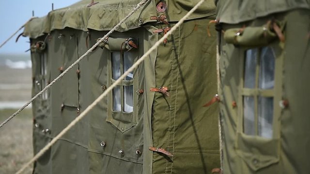 Closeup video with a green military tent
