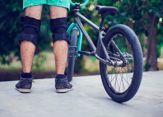Rear view of a young man bmx biker siting on his bike