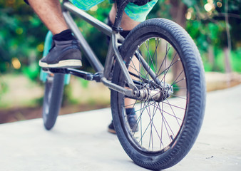 Rear view of a young man bmx biker siting on his bike