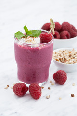 Fresh raspberry smoothie with nuts, vertical