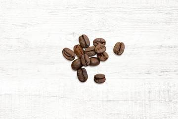 Roasted of coffee beans on white wood background.