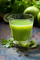 glass of juice of celery and greens, vertical, closeup