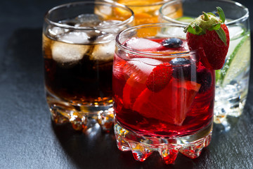 iced fruit drinks on a dark background, closeup
