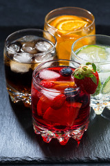 iced fruit drinks on a dark background, vertical, closeup