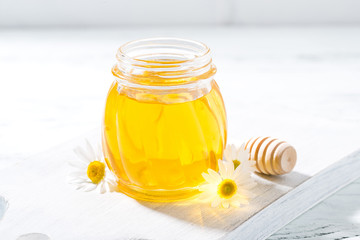 jar of fresh honey on a white background