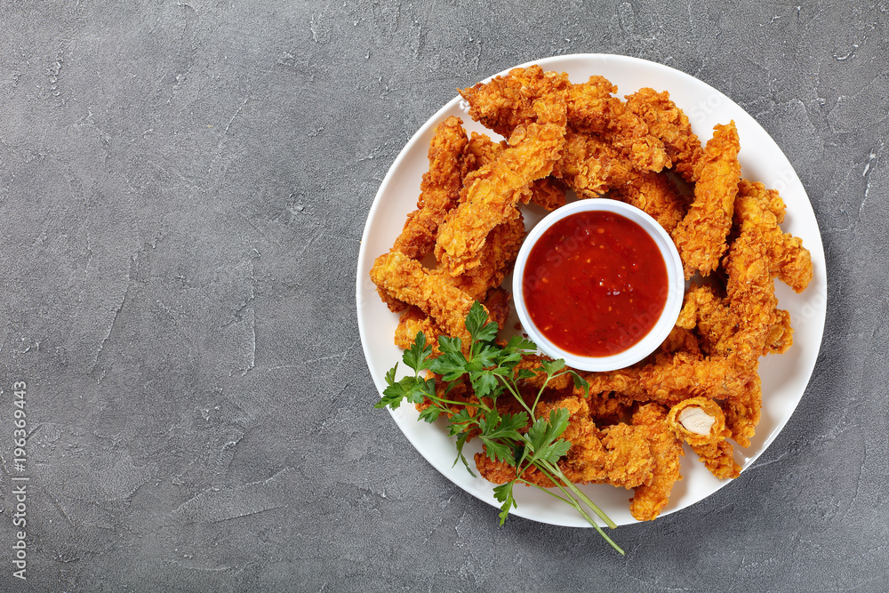 Sticker crispy fried chicken breast strips on plate