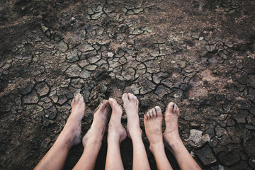 Feet of children on cracked dry ground .concept hope and drought