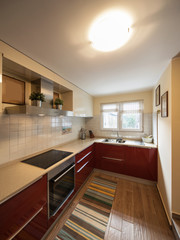 Red modern kitchen with new appliances