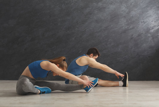 Fitness couple at stretching training indoors