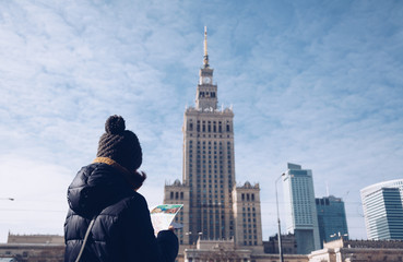 Young tourist with map against the Palace of Culture and Science - Warsaw