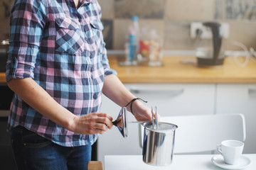 the girl is preparing morning coffee. the girl is preparing breakfast.