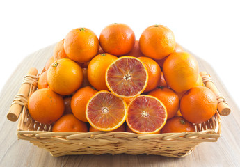 Fresh orange, organic ripe mandarins, pile of orange, sliced orange in wood basket on wooden table background with clipping path.