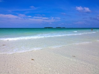 Ocean view of blue sky, beautiful clouds and pacific crystal turquoise water beside a tropical island with powdery white sand .  Cayo Guilermo , Cuba 