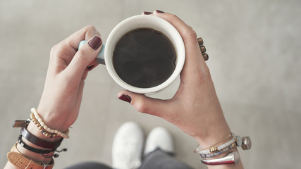 Woman both hand holding coffee cup