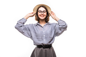 Portrait of pretty joyful girl in straw hat ready for journey posing in studio over white background.