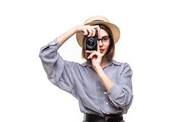 Smiling blond young woman in straw hat taking a photo on white background