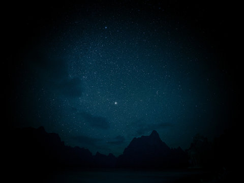 Stars and night sky over lake background