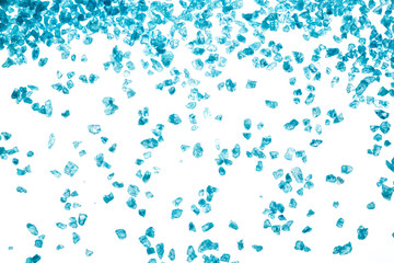 Blue crystals of sea salt on white background