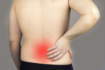 Fototapeta na wymiar .A man holds on to his back, his back hurts, his red back, .dorsal hernia, intervertebral hernia