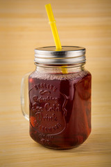 jar of cherry juice on wooden background