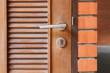 wooden door with orange wall block   