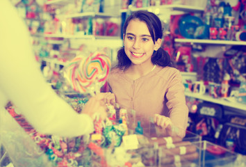 Schoolgirl buying sweet lollipop