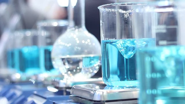 Scientist mixing chemicals in erlenmeyer flask