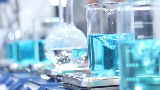 Scientist mixing chemicals in erlenmeyer flask