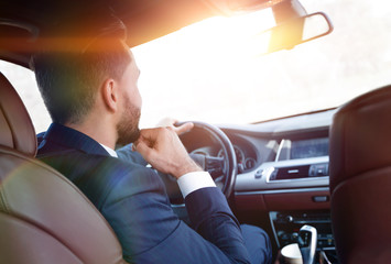 Confident businessman in his car.