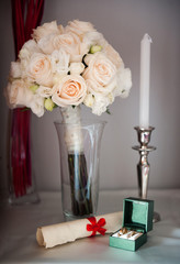 Wedding still life with rings and white roses