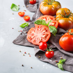 Assortment of ripe organic farmer red tomatoes on a table