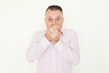 Shocked emotional man covering mouth in excitement