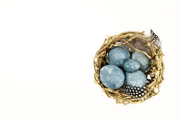 Color vintage eggs in the nest isolated on white