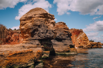 Fototapeta na wymiar cliffs, sharp stones rocks along coast see