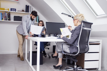 Group of young people working on curent project in office