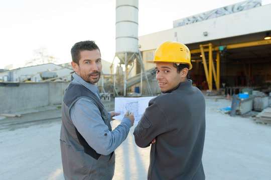 two engineers looking at camera at plant site
