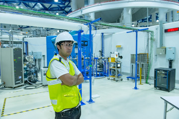 Asian engineer working at Operating hall,Thailand people wear helmet  work,He worked with diligence and patience