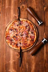 Pizza with bacon and cheese on wooden background