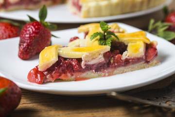 The strawberry pie in the wooden background