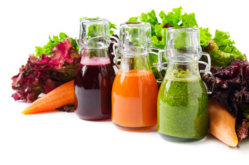 Fresh vegetable juices isolated on white