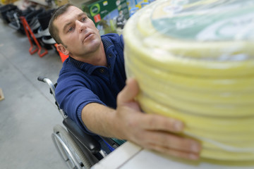 man in a wheelchair buying conduit nylon pipe