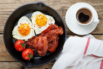 English breakfast - fried egg,tomatoes and bacon.top view