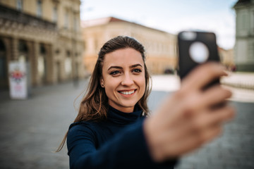 Young woman making a selfie at the city.