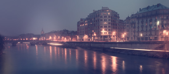 View on the night light of buildings near river in Grenoble of F