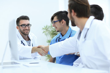 Fototapeta na wymiar handshake between the two doctors during the working meeting